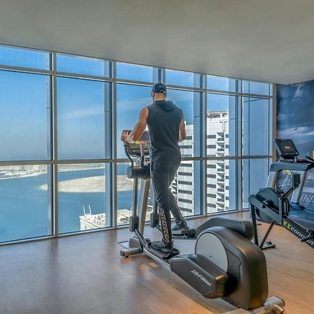 Pullman Sharjah Hotel Kültér fotó A man using a cross trainer