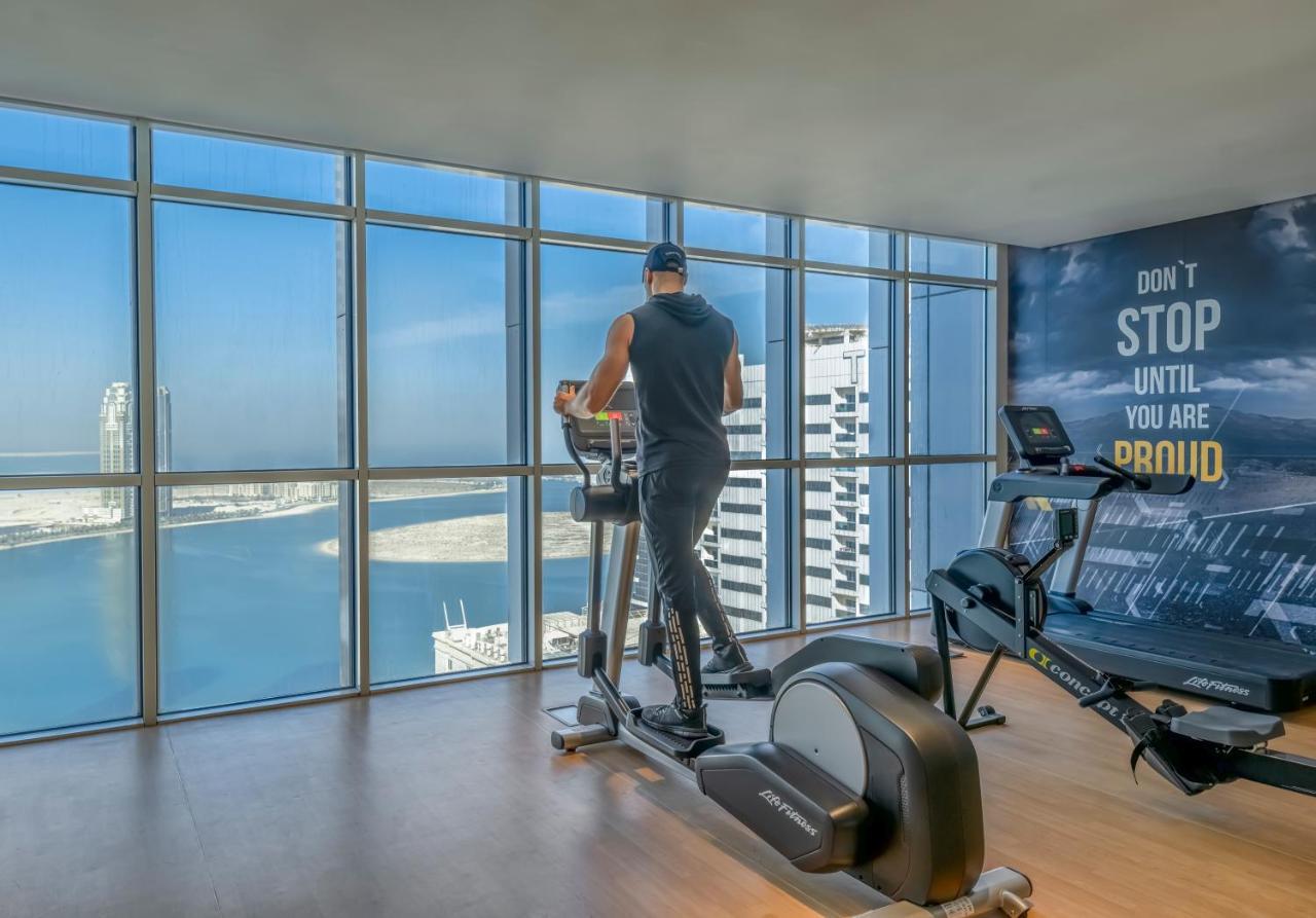 Pullman Sharjah Hotel Kültér fotó A man using a cross trainer