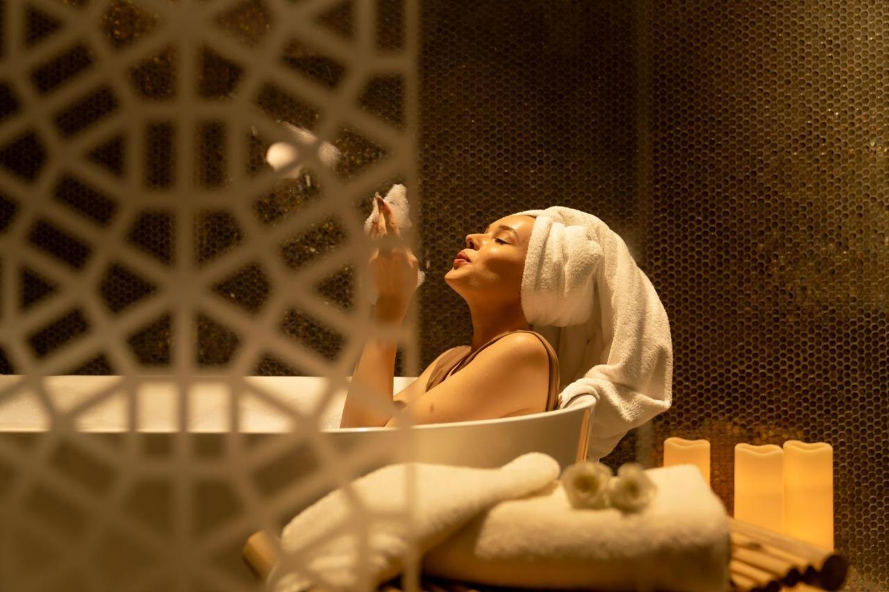 Pullman Sharjah Hotel Kültér fotó A woman in a spa